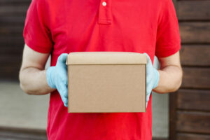 shipping and delivery of discreet cannabis package by courier wearing gloves